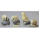 Four carved Tagua nut figures of animals, comprising: seal lion, 7cm high; panda, 6cm high; small