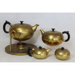 German Art Deco style brass tea set, comprising: tea kettle on stand (lacking burner); teapot; small