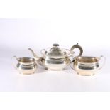 George V silver three piece tea set of boat shape having feathered edge by Harrison Brothers &