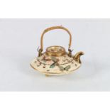 Miniature Satsuma teapot of flattened shap with bamboo handle, the compressed form with decoration