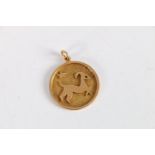 Eastern 18ct gold pendant depicting a ram and star on a textured field, stamped "??" (18 in Arabic