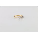 18ct gold and platinum three stone diamond ring, the central stone approximately 0.25cts, ring