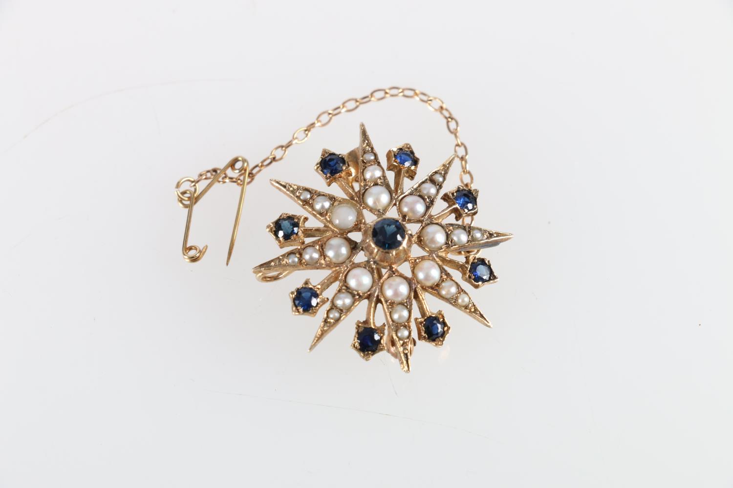 Unhallmarked yellow metal star brooch set with seed pearls and sapphires, makers mark H&SL, 4.9g,