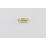 18ct gold diamond five stone dress ring, the central stone approximately 0.2cts, size M 4.5g