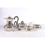 Victorian silver four-piece tea set with gadrooned bottom half and gilded interior by Samuel