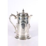 Victorian silver lidded ewer with applied lion masks, shell thumb piece and allover engraved
