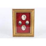 Framed display of four antique portrait miniatures, each apparently unsigned, the largest 5.5cm x