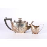 Victorian silver teapot and matching milk jug with allover embossed foliate decoration by Plante &