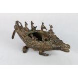 A 19th century Indian cast bronze model of an alligator with eight musician riders and an oarsman,