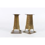 A pair of English Art and Crafts copper and brass candlesticks bearing the mark of Arthur John