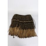Maori Pui Skirt made from dried flax leaves, with black decorative banding on the cream leaves