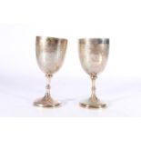 A pair of Victorian silver goblets with allover incised decoration, the cartouches with boars head
