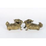 A pair of late 19th or early 20th century bronze lion dogs, gilded, with incised decoration, 19cm