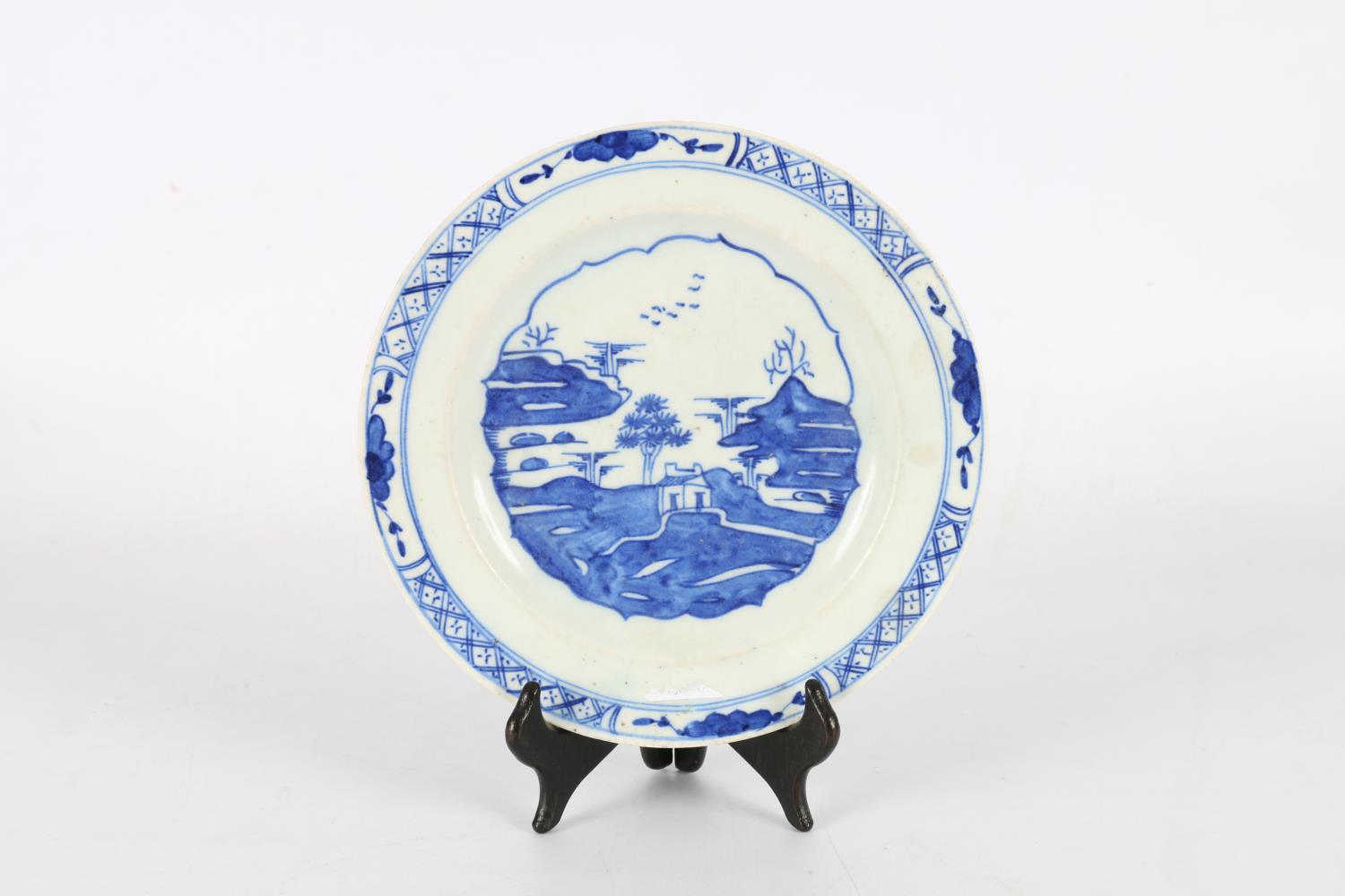 Mid 18th century Bow blue and white plate with central Chinese pavilion pattern within a lotus