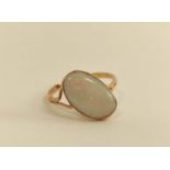 Opal ring with split shank mount, set at an angle.