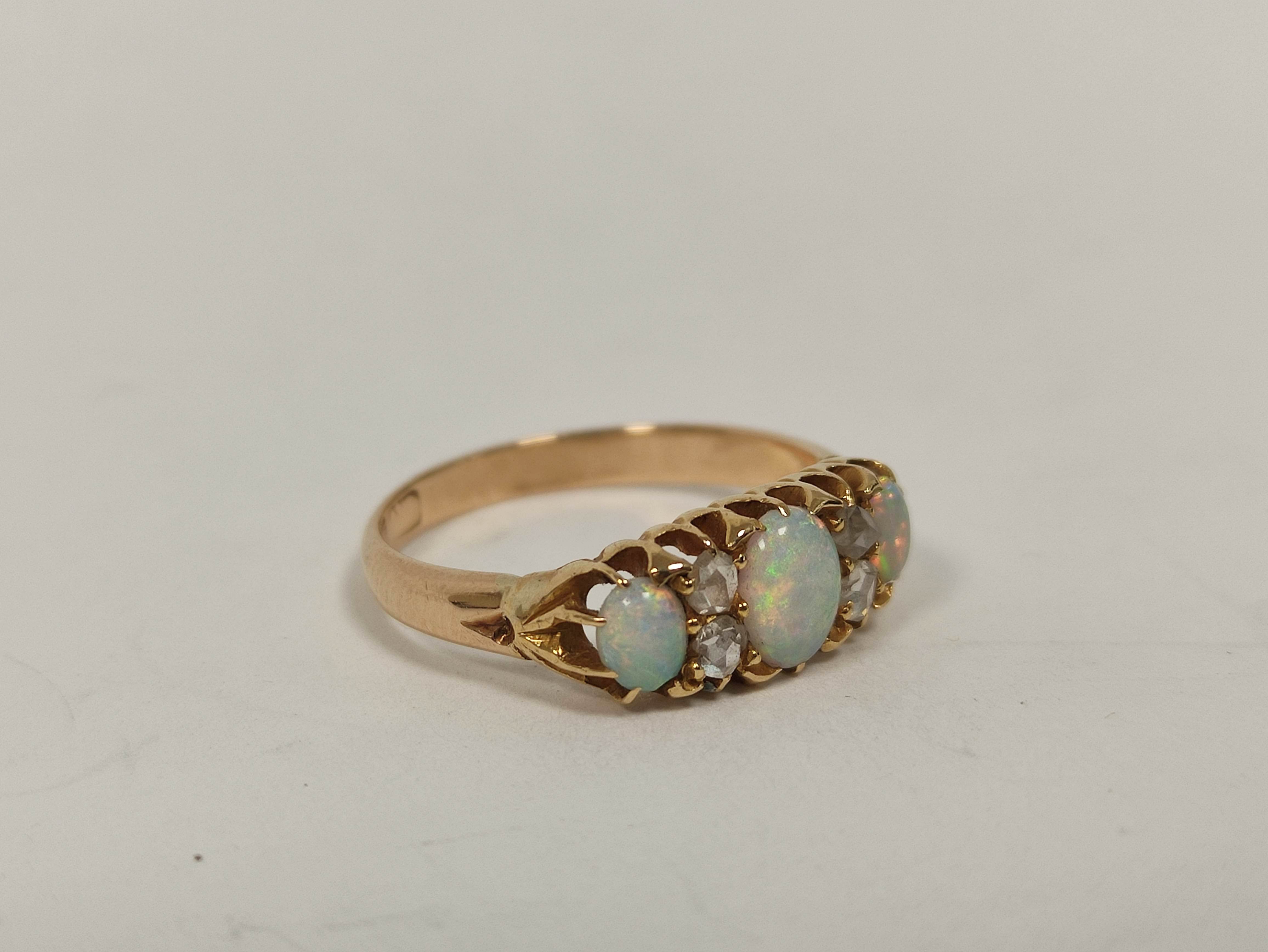 Gold ring with three opals and diamond points, probably 9ct. Size 'M'.