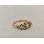 Gold ring with three opals and diamond points, probably 9ct. Size 'M'.