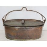 Large 19th century copper fish kettle of oval form with swing handle and lift-out trivet, 61cm long.