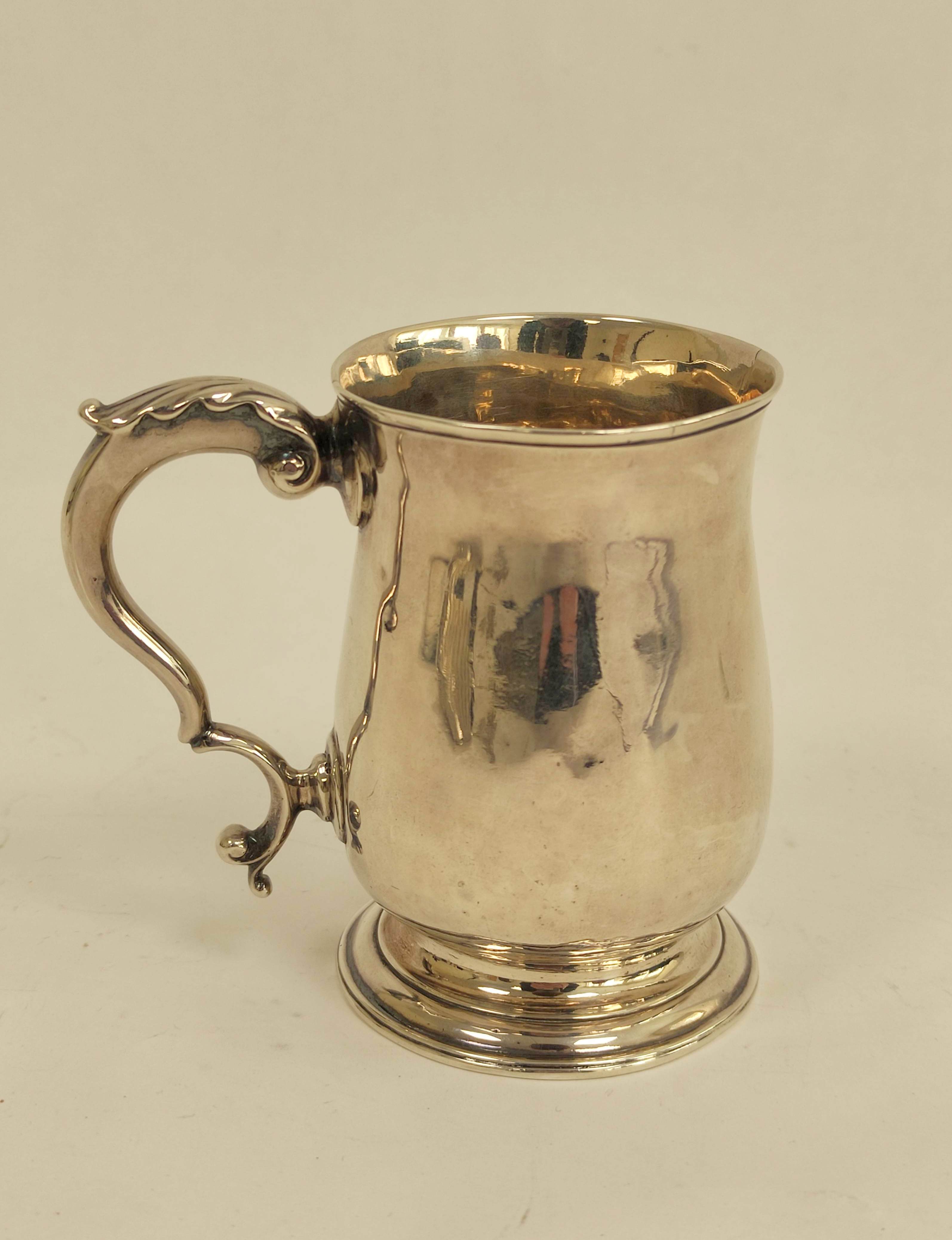 Silver baluster mug with leaf capped scroll handle, initialled maker's mark overstruck by that of