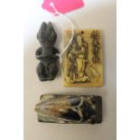 Three Chinese archaic and archaised jade carvings to include a seated grotesque figure, a stylised