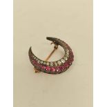 Victorian crescent brooch with graduated old cut rubies and old cut diamond brilliants. 4.6g.