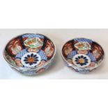 Graduated pair of Japanese Imari bowls with panels of flowers and mythical creatures and silver