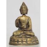 Eastern bronze figure of a Buddha seated on a lotus throne, hollow base, 15cm high.