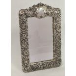 Easel mirror in electrotype silver embossed frame.