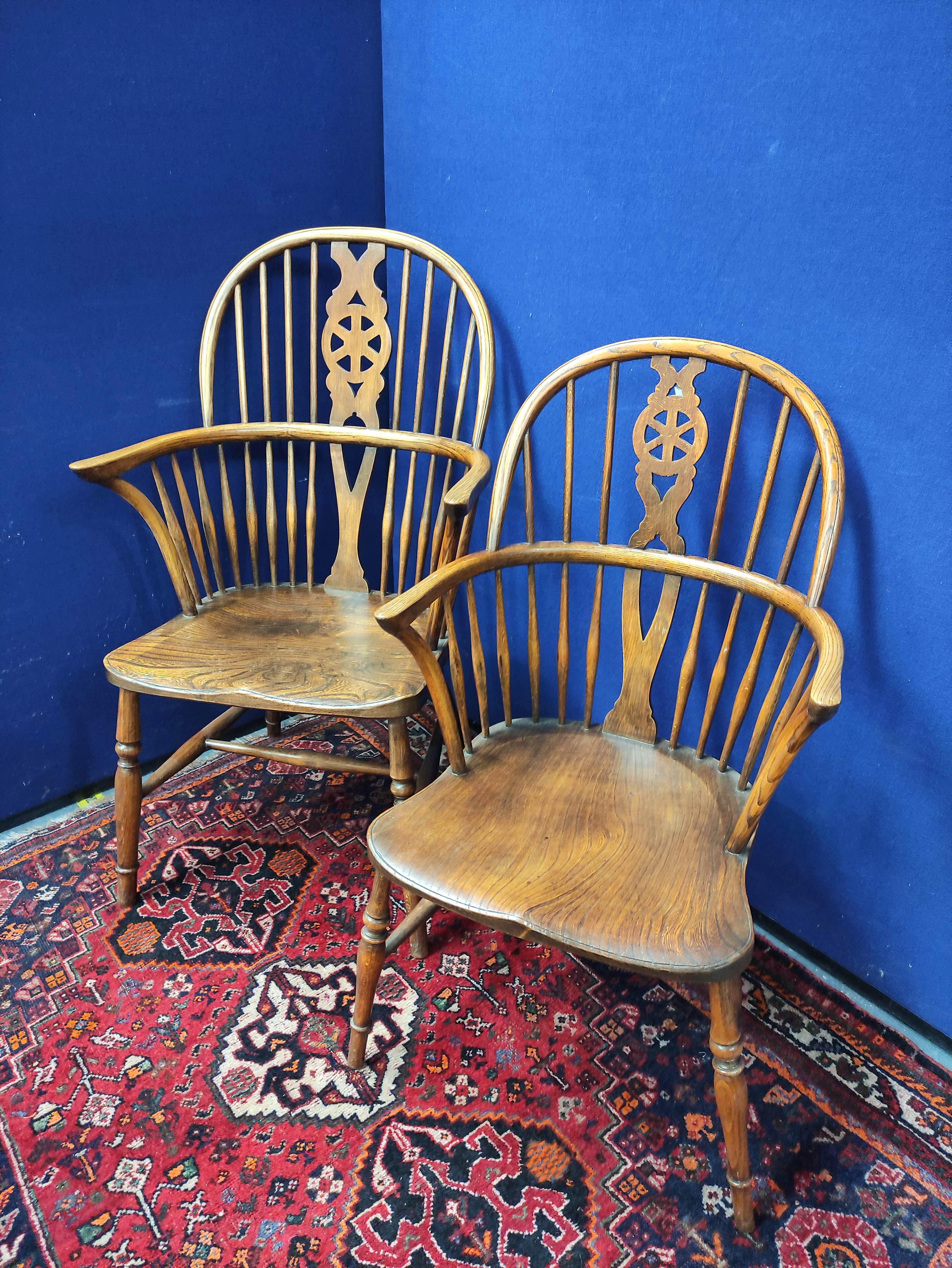 Pair of near matching ash and elm Windsor armchairs, both with spindle hoop back, with pierced splat