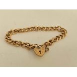 9ct gold curb bracelet with padlock. 23g.