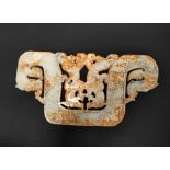 Large Chinese jade plaque in archaic style, depicting stylised dragon heads, 25cm wide.