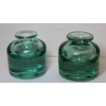 Two 19th century heavy green glass inkwells of cylindrical form with sloping shoulders, short neck