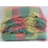 Welsh wool waffle blanket woven in pastel pink, yellow and green checks.