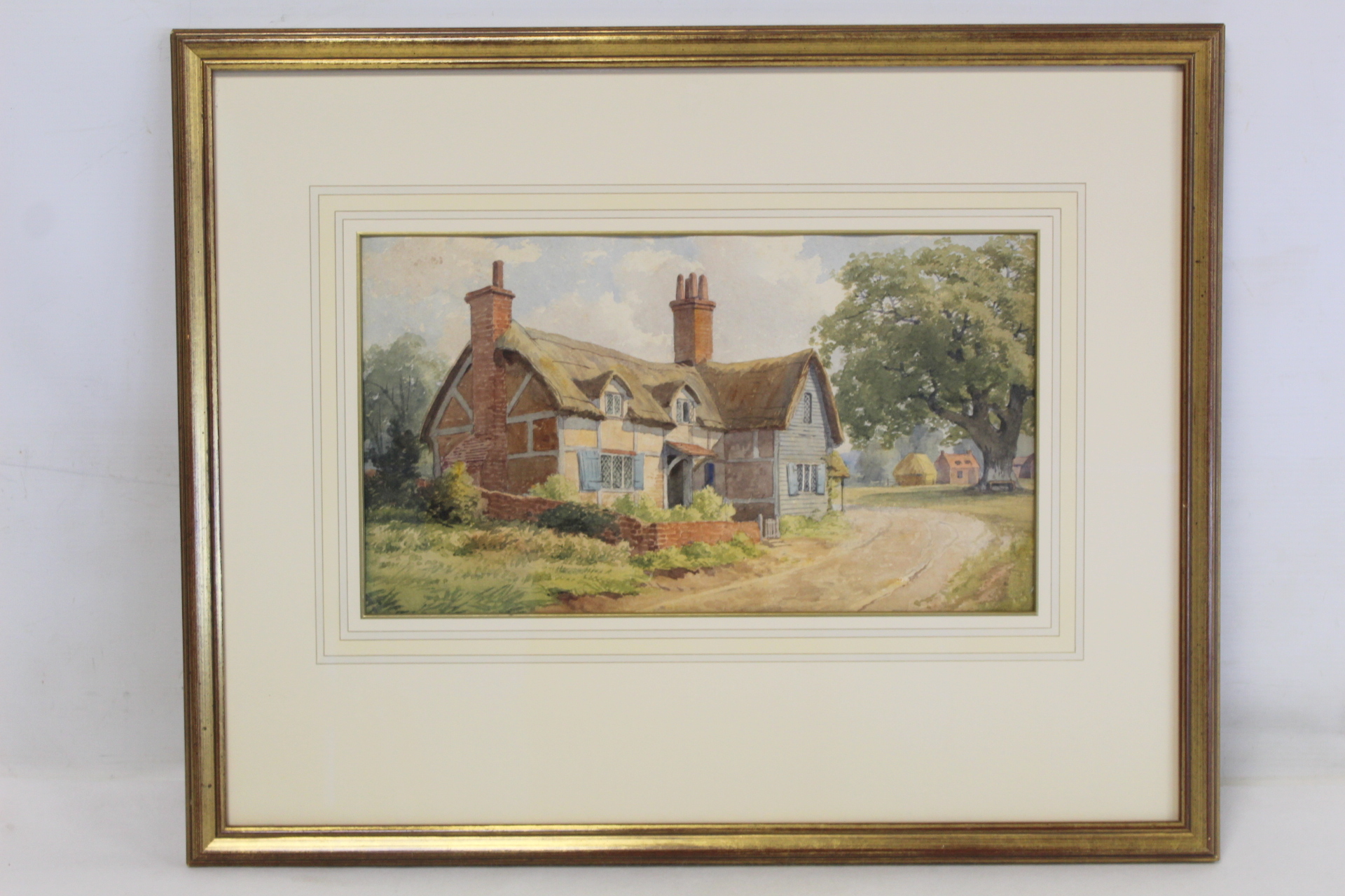 LATE 19TH/EARLY 20TH CENTURY ENGLISH SCHOOL. Thatched farmhouse. Watercolour. 19.5cm x 45cm.