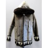 Lady's sealskin jacket with single zip fastening, hood with fur border and geometric borders to
