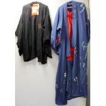 Japanese black silk kimono jacket with woven floral and foliate decoration and a blue kimono
