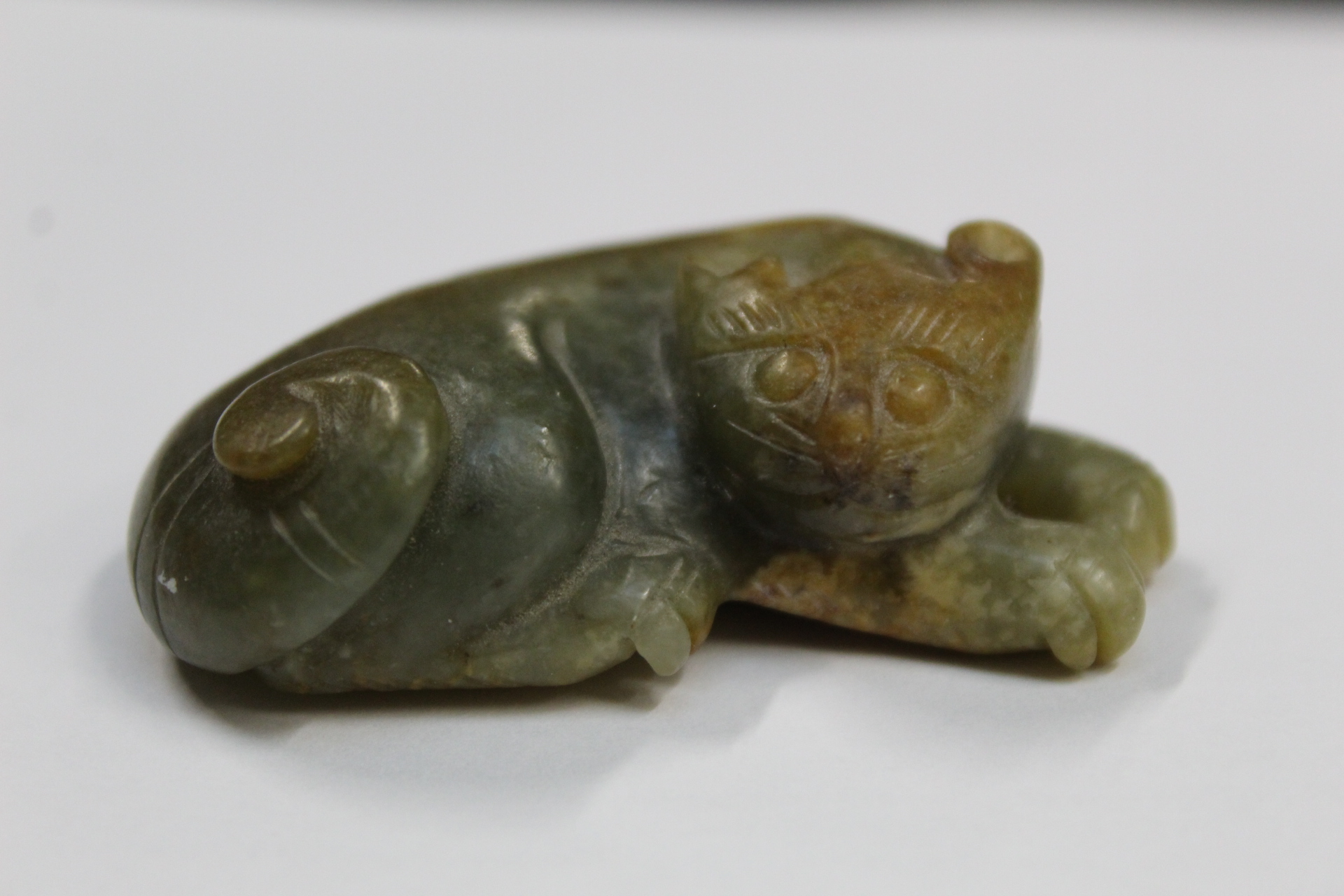 Three Chinese archaic and archaised jade figures to include a repose cat figure, a rectangular - Image 4 of 14