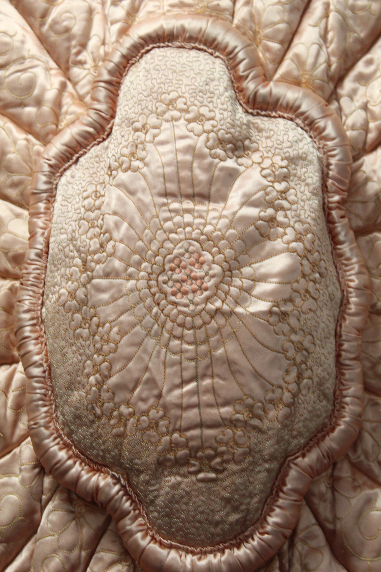 Early 20th century eiderdown of peach satin quilted and embroidered decoration, cotton backed, - Image 3 of 7