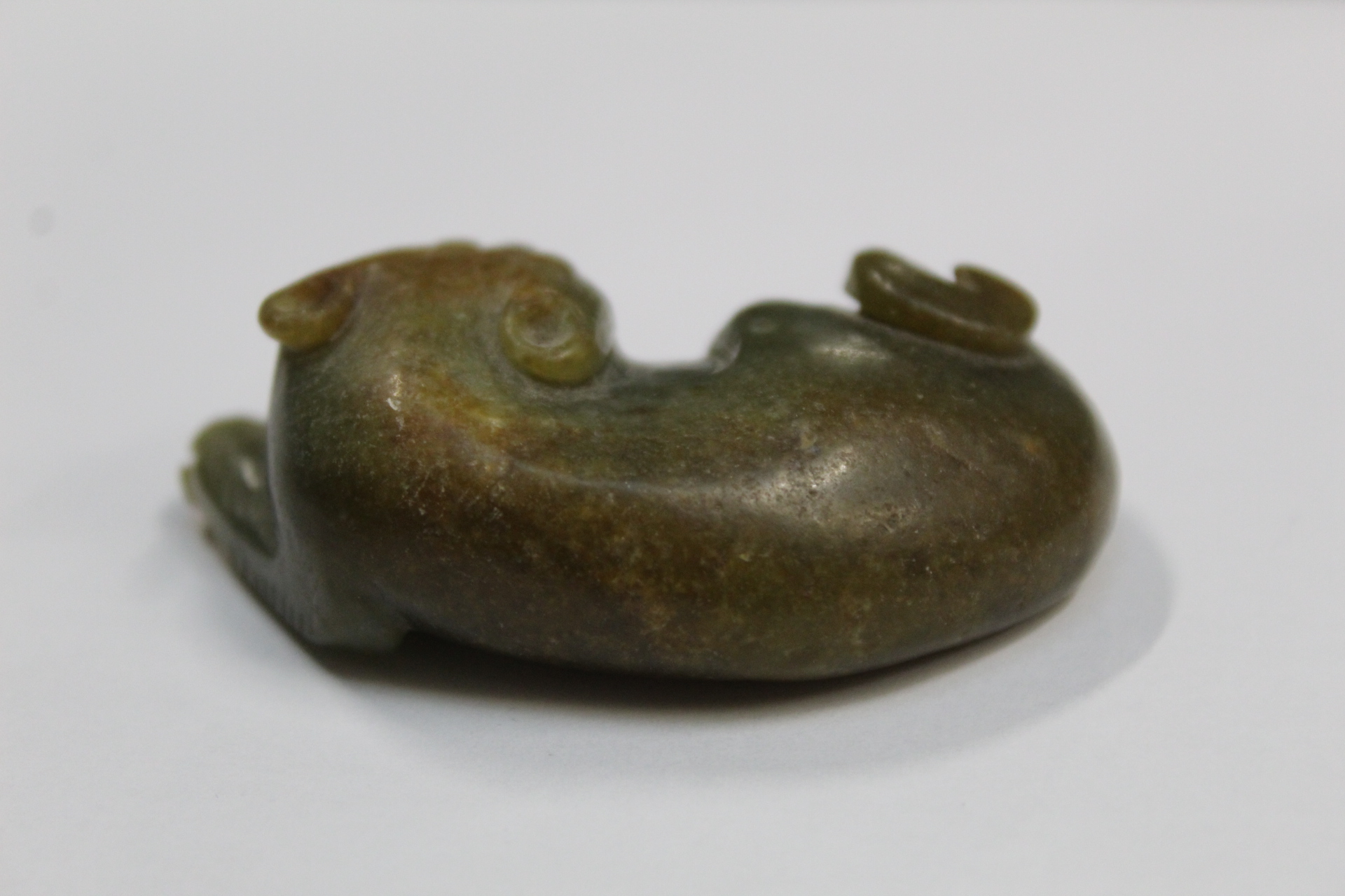 Three Chinese archaic and archaised jade figures to include a repose cat figure, a rectangular - Image 6 of 14
