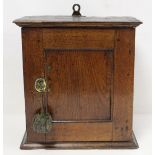 Small Georgian oak hanging cupboard of rectangular form, the panelled door opening to reveal three