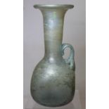 Antique glass flask or ewer, possibly Roman, the flattened globular base with tall flared neck,