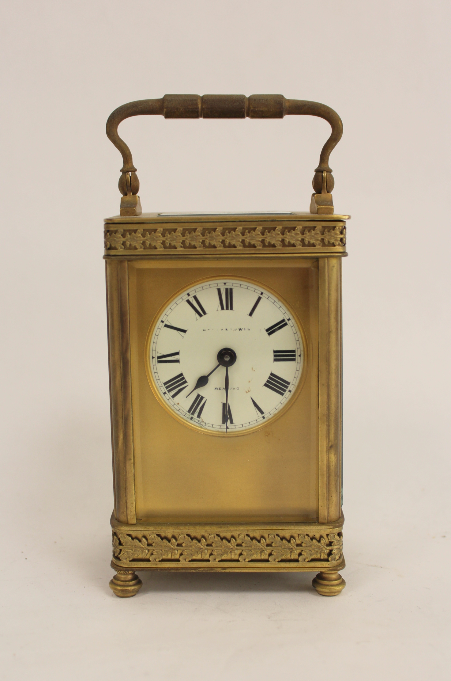 Cylinder carriage timepiece with gilt mask and bands of pierced leafage. 13cm.