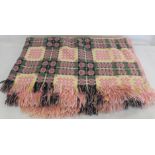 Welsh wool blanket woven in pink, pale yellow and green with geometric patterns.