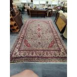 Indian Carpet decorated with a large floral medallion to the centre, within all over floral panels