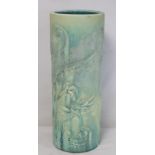 Large Bretby pottery cylindrical stick stand with moulded matt green drip glazed decoration of two