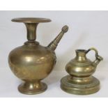 Two Eastern brass hookah bases, one of baluster form with flared rim, twisted conical spout with bud