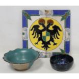 Pair of Continental faience pottery tiles forming a crest with double headed eagle, each 28cm x 13.