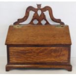 Georgian oak candle box of rectangular form with fret cut pierced back, sloping hinged lid, inlaid