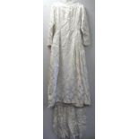 Vintage wedding dress, probably 1960's, in white floral satin damask with high round neck, fitted