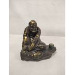 19th century Chinese bronze figure of a seated mendicant with alms bowl, traces of gilding, 18cm